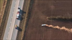 Car chase in a field